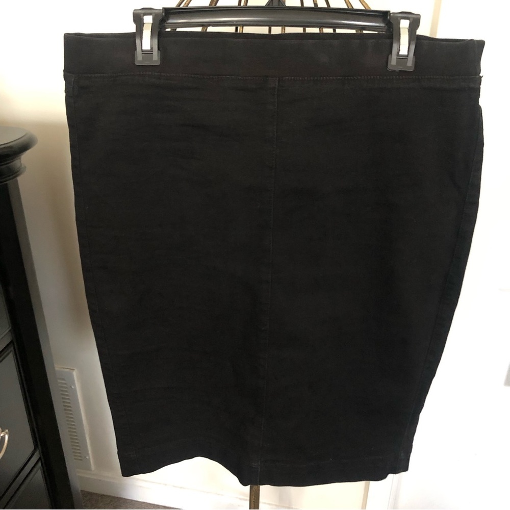 Black denim skirt with split in the back.